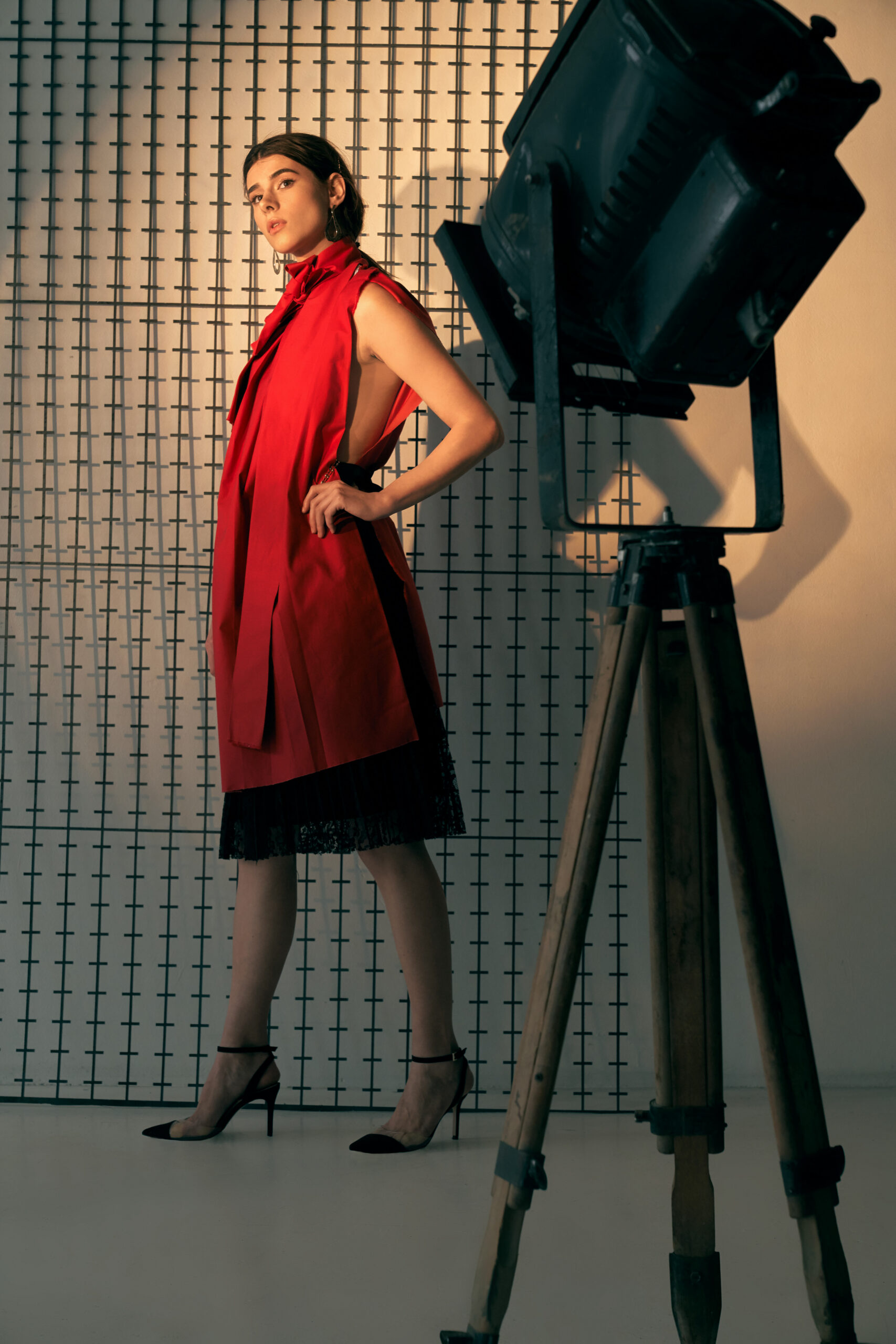 Lady in red posing in studio.
